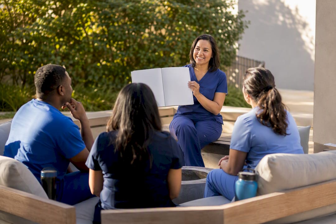 Hands placing HIPAA manual on table in training