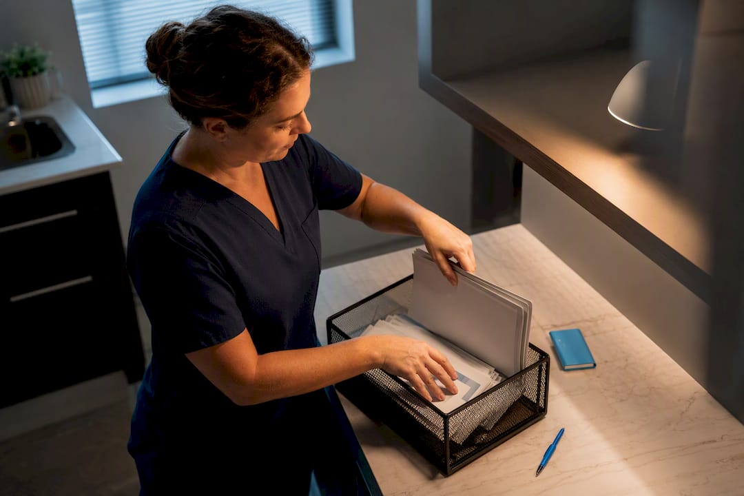 Coordinator sorting physician referral intake materials