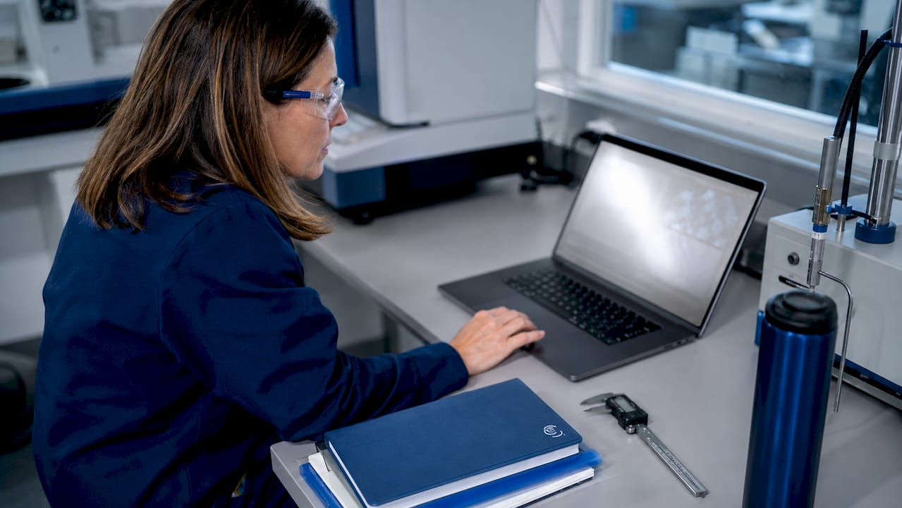 Engineer reviewing NDT video footage on laptop