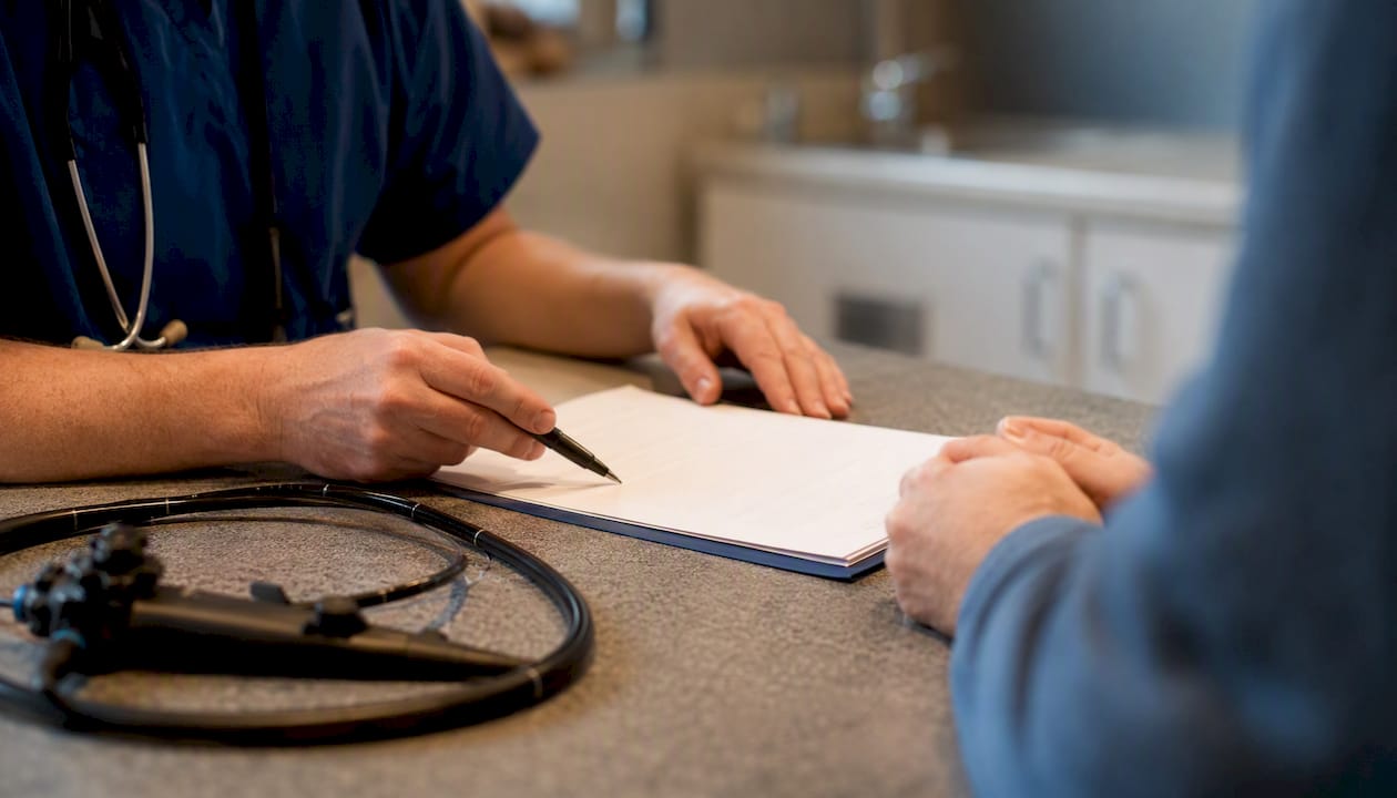 Hands adjusting veterinary endoscope lease contract