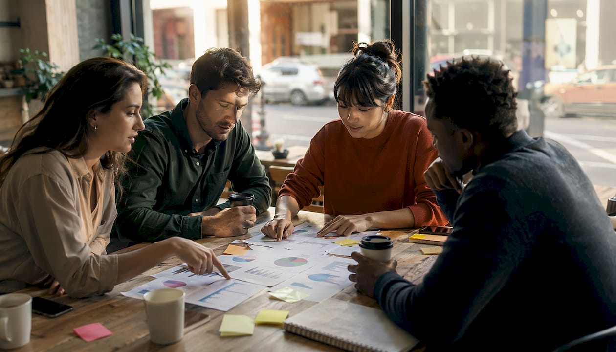 Group collaborating around table in coworking space