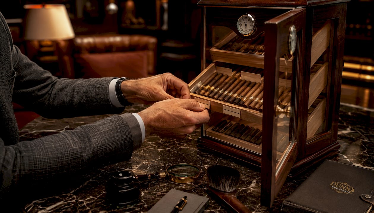 Hands labeling sections in luxury humidor