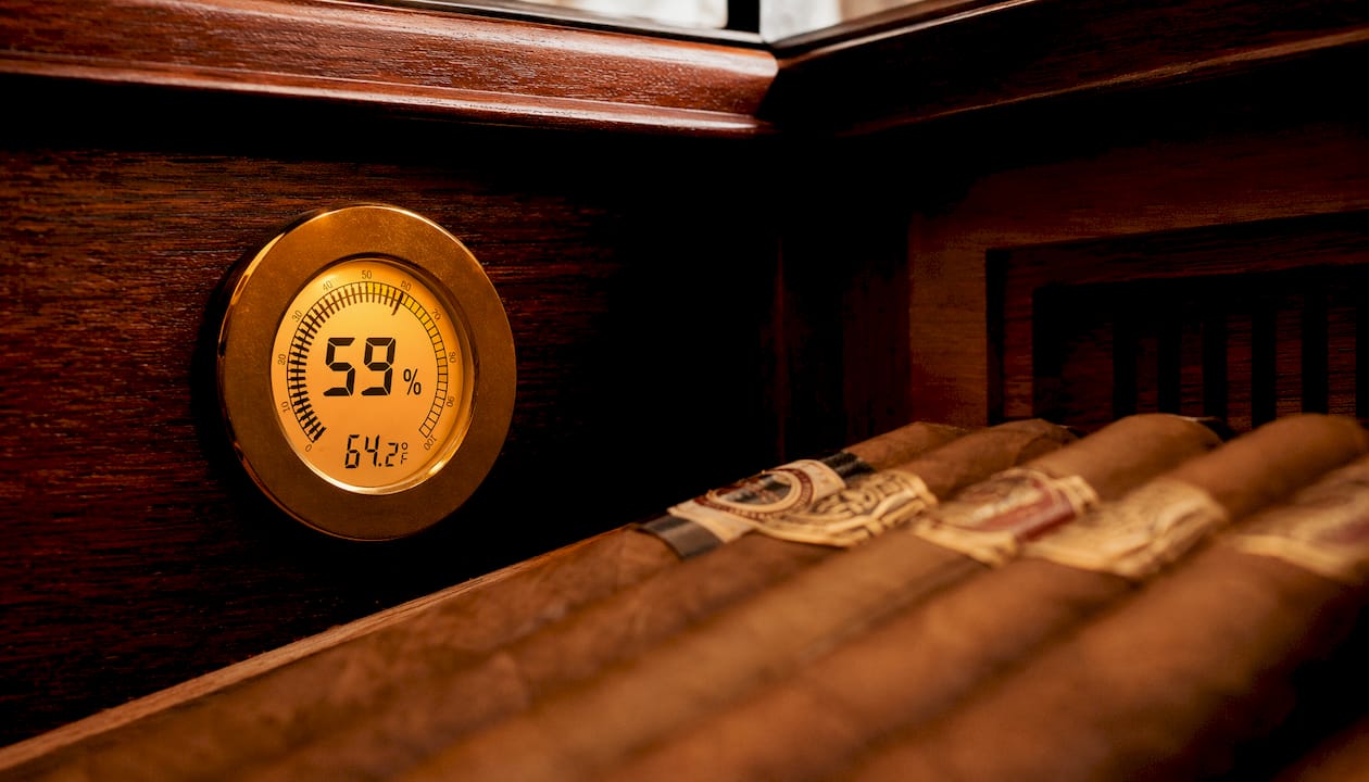Close-up of digital hygrometer inside wooden humidor