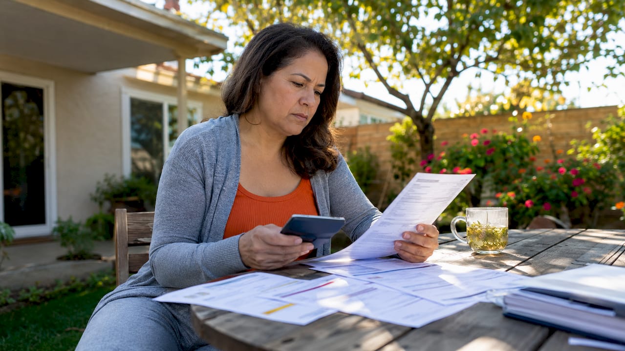 Homeowner reviewing AC repair vs replacement options