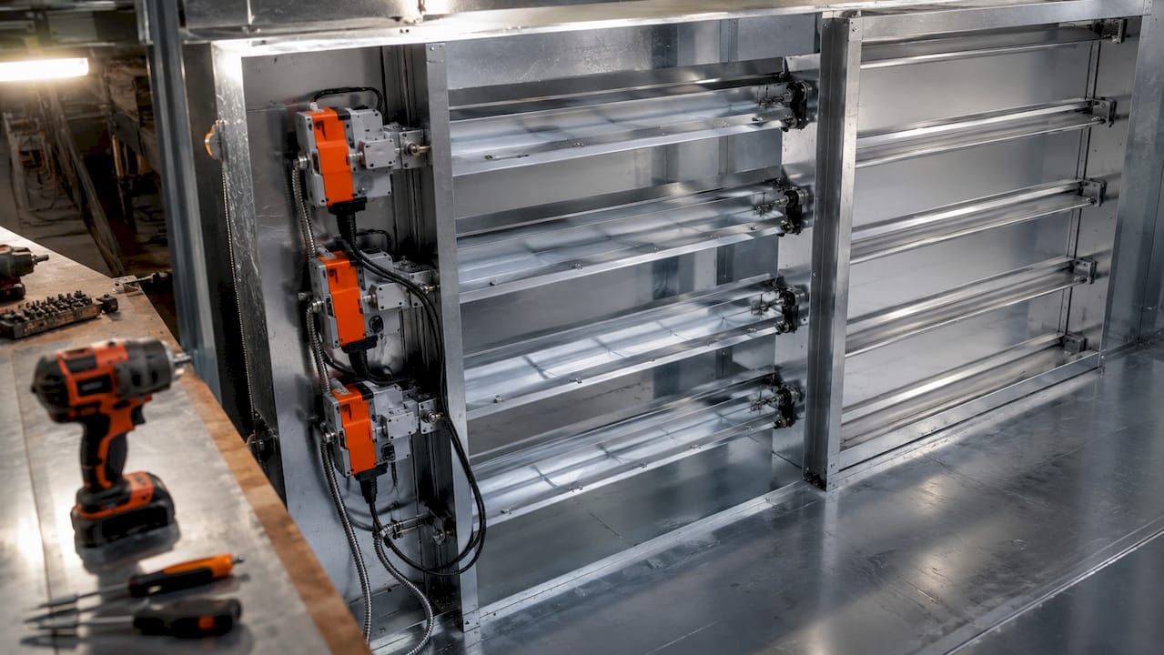 Close-up of HVAC economizer damper blades and actuators