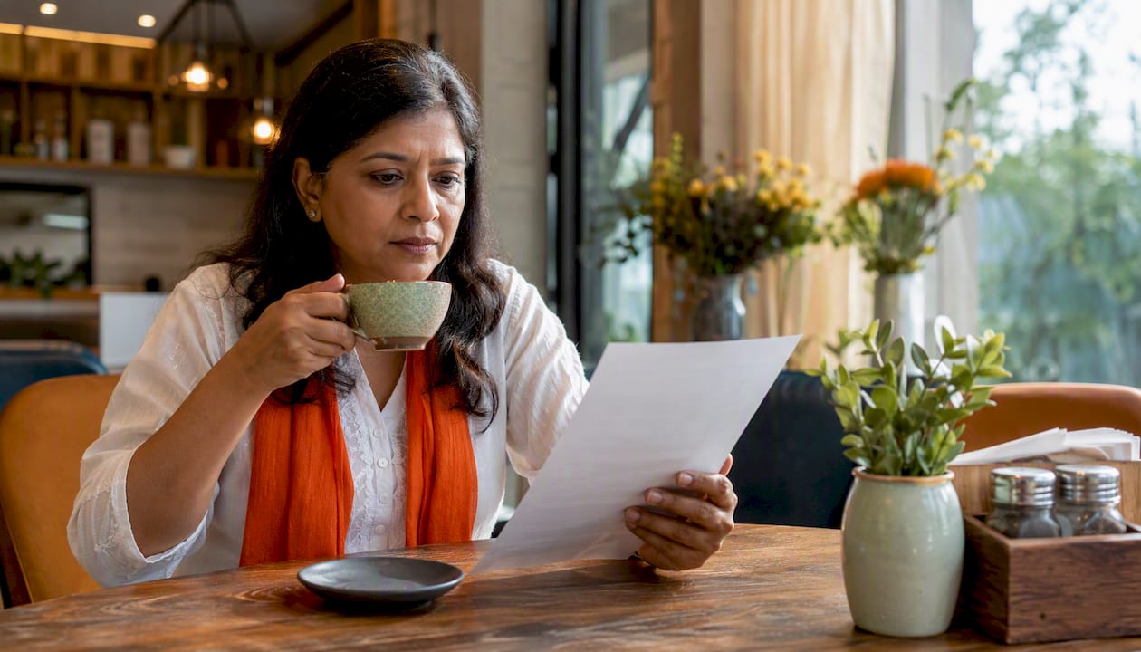 Homeowner reviewing HVAC contractor options at kitchen table