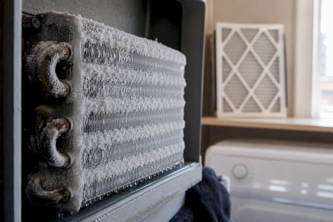 Frozen evaporator coil with ice buildup in AC unit