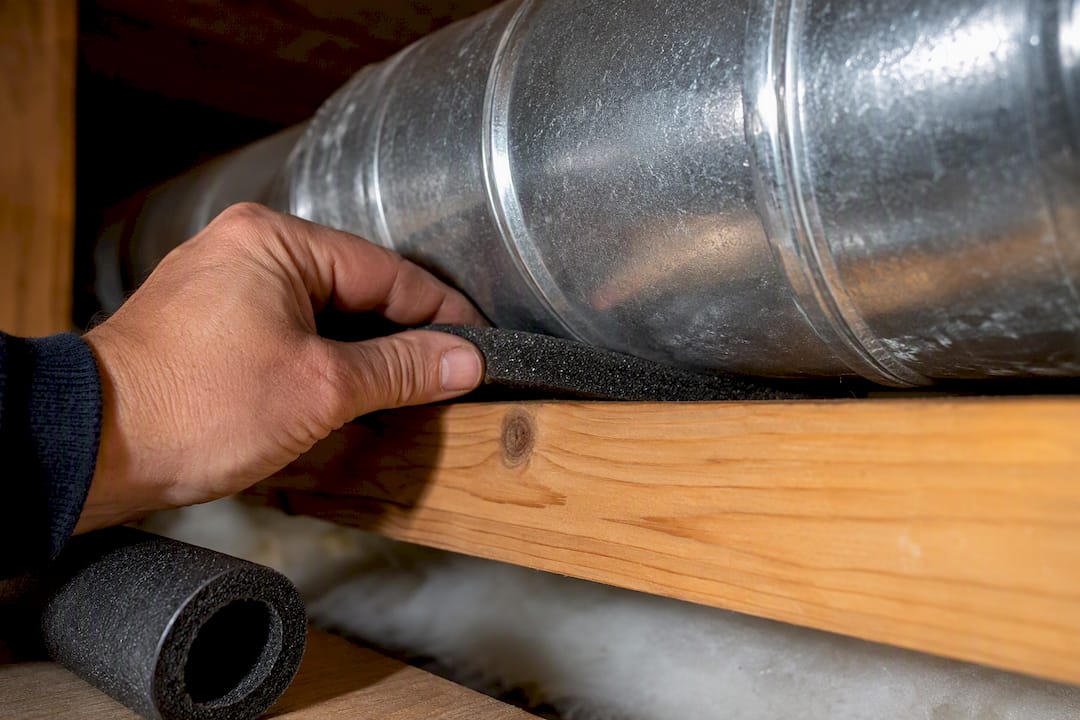 Foam strip separating duct from framing