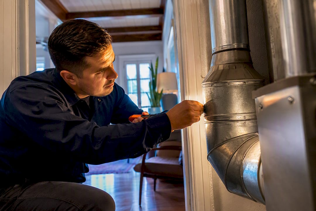 Technician inspecting home air quality conditions