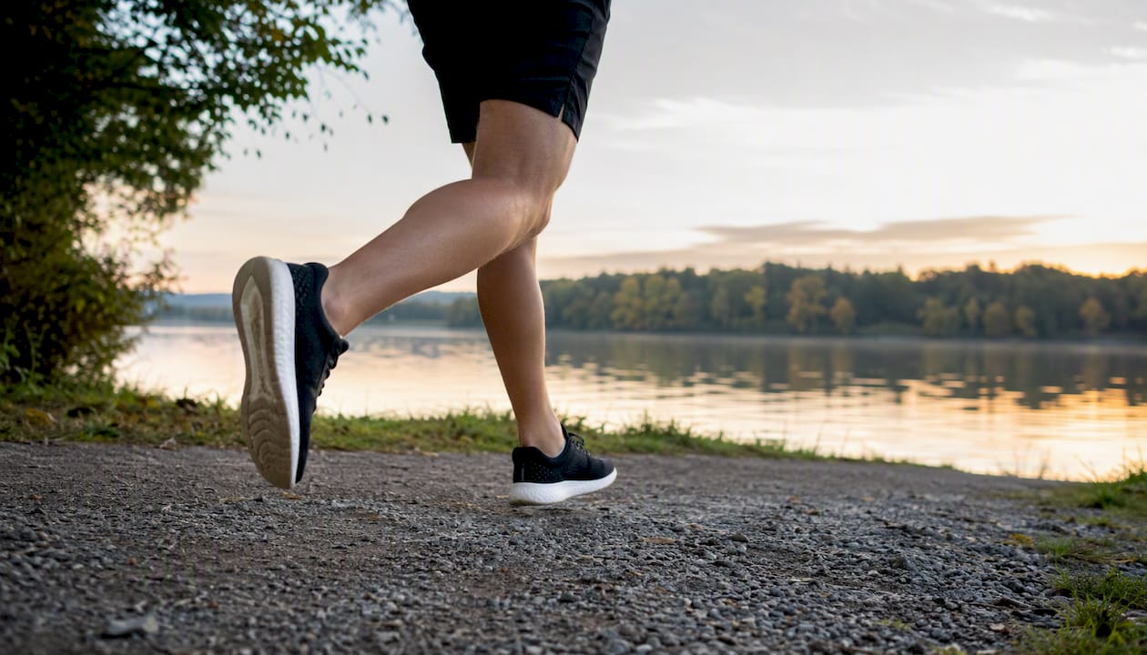 Lower legs of person jogging on park trail