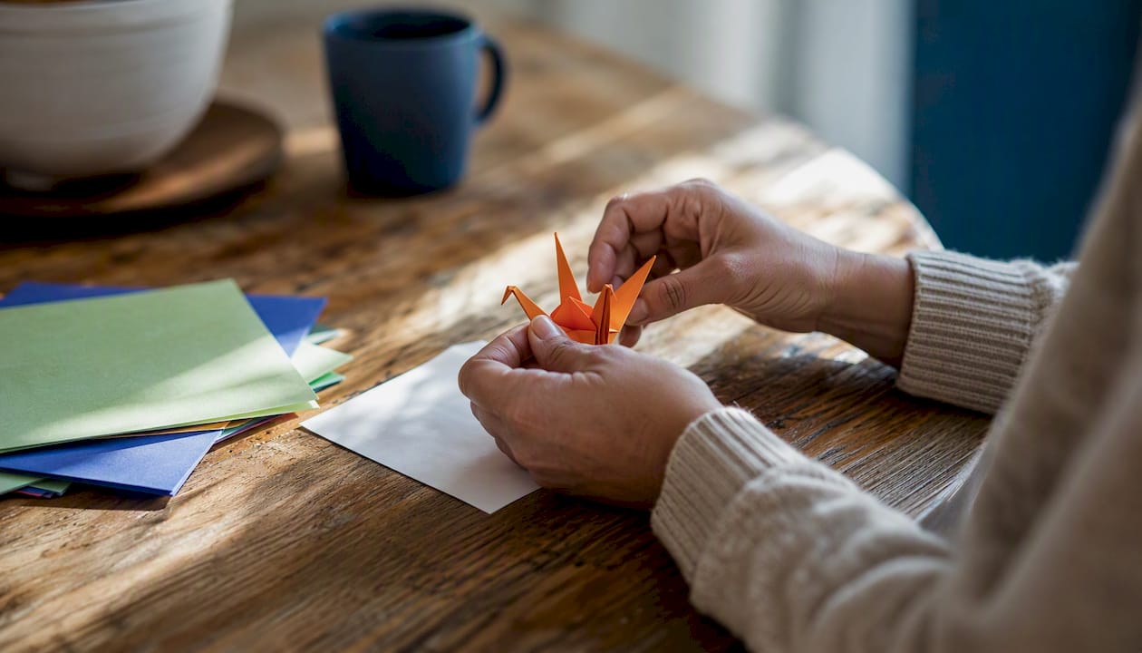 Hands folding letter as supportive gesture