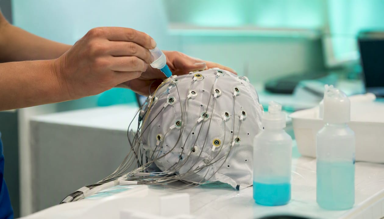 Technician applying gel to EEG electrodes