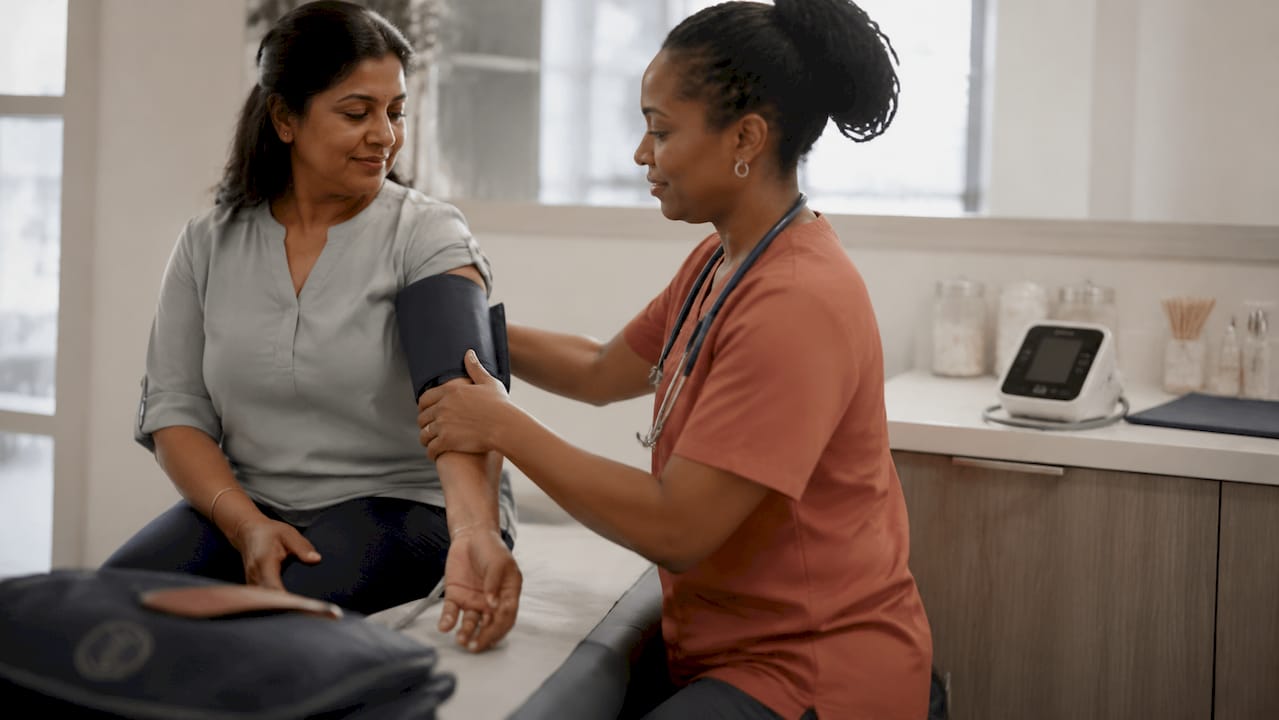 Healthcare provider measuring patient blood pressure