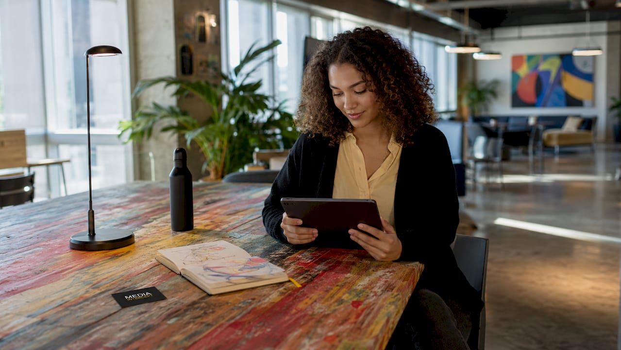 Woman checking newsletter content metrics on tablet