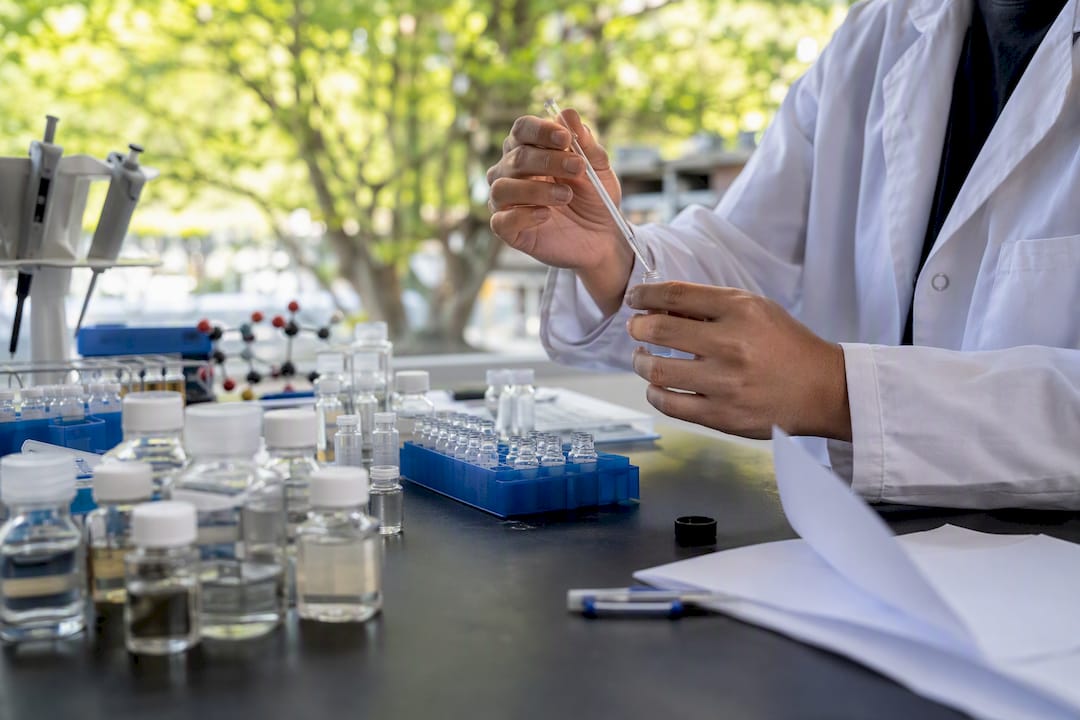 Hands preparing oxidative reagent in lab