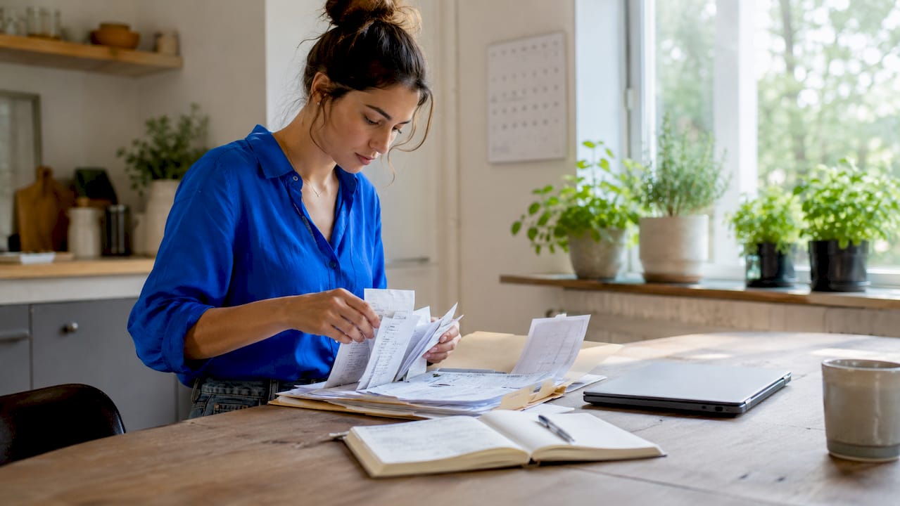 Accountant sorting receipts at home desk