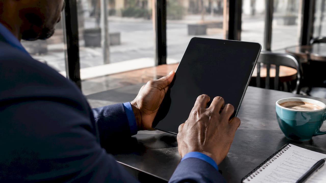 Hands scrolling subscription plans on tablet