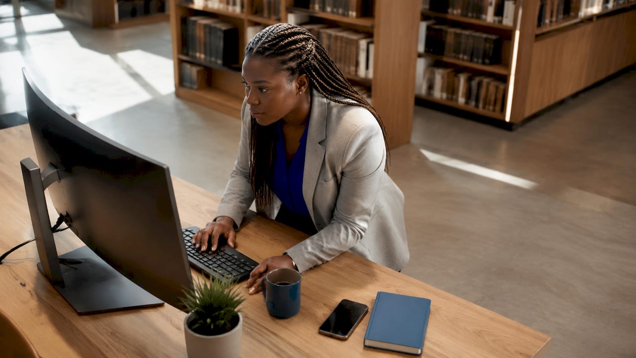 Woman analyzing business intelligence AI data at desk