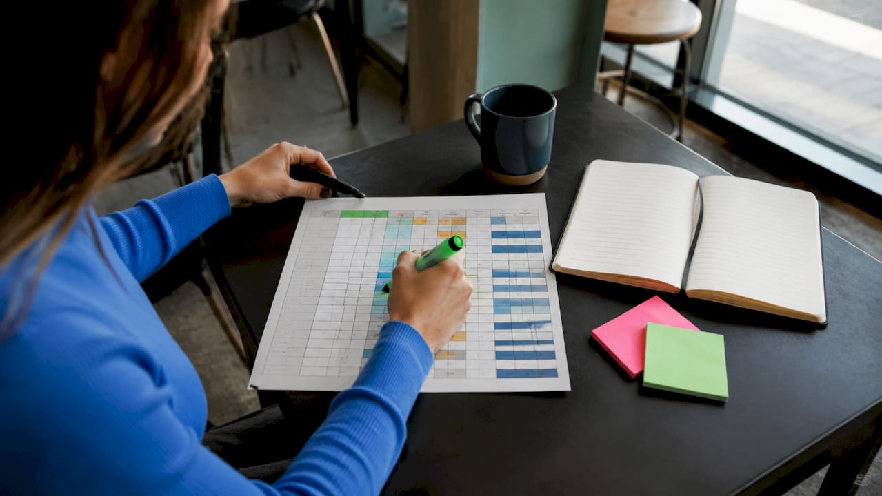 Hands annotating data classification chart