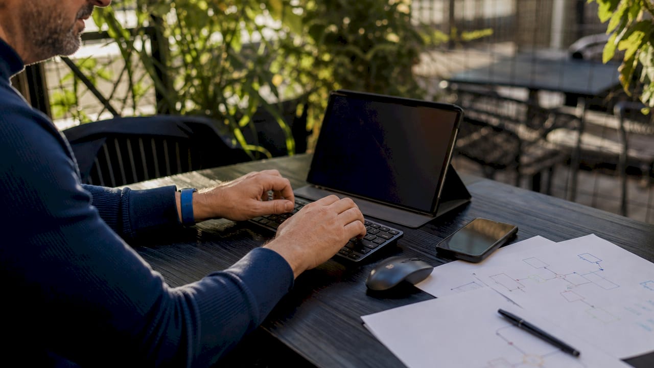 Hands typing in startup AI integration workspace