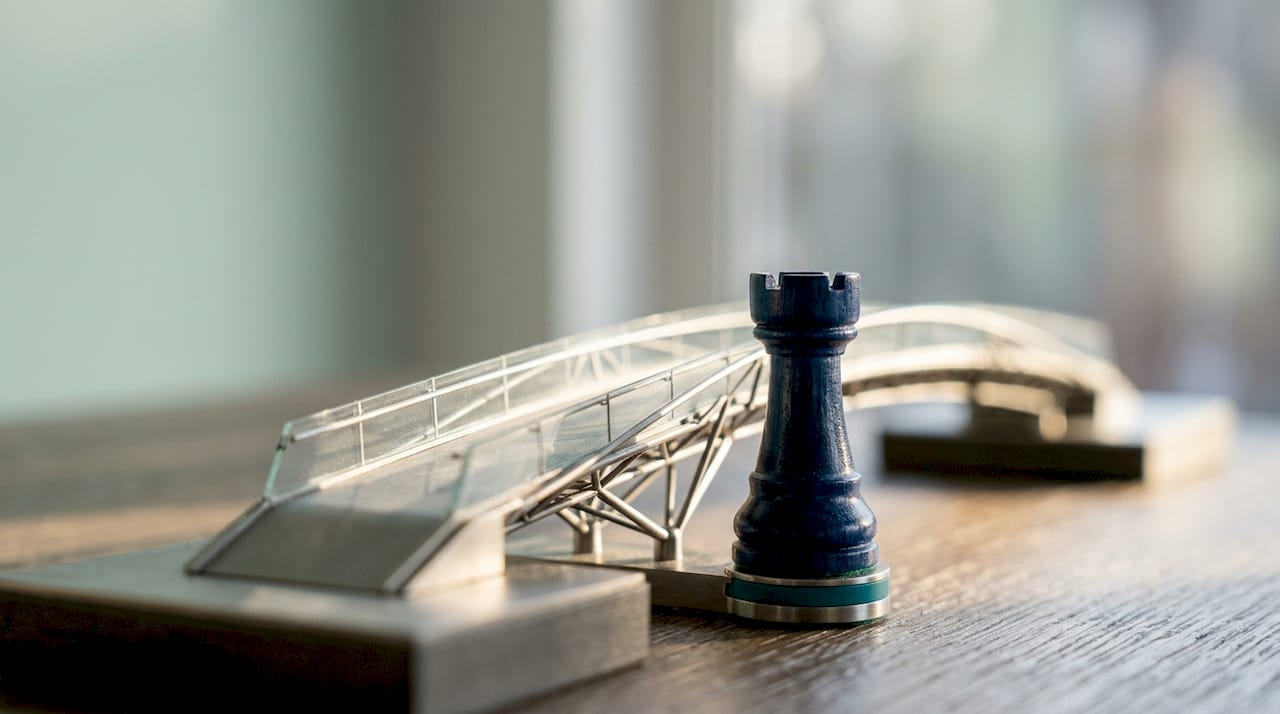 Macro shot of chess rook near miniature modern bridge