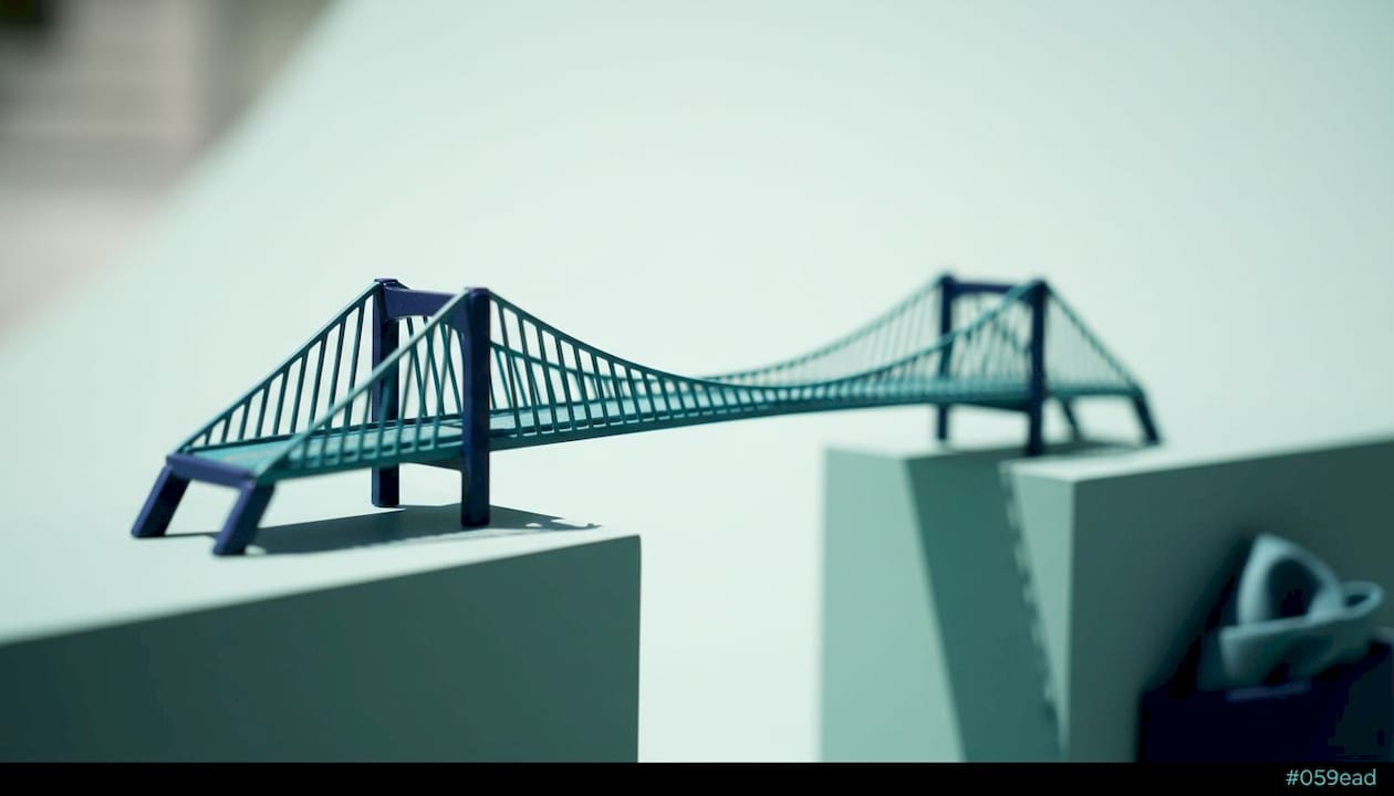 Close-up of a modern bridge model in teal and navy