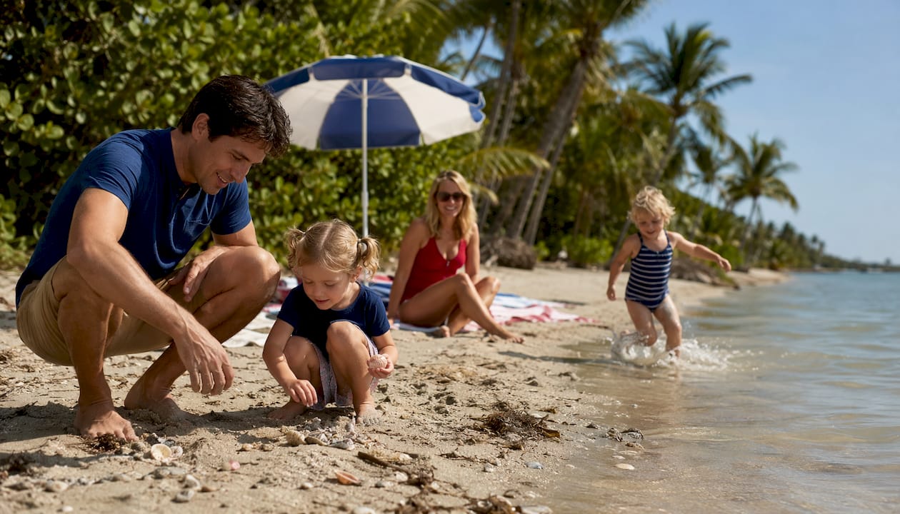 Family playing safely at Captiva Island beach