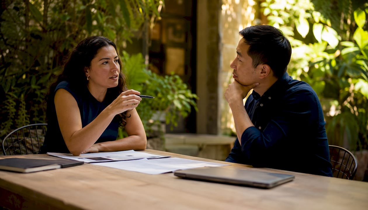Two scholars discussing tax ethics at seminar