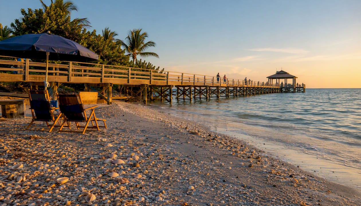 Pier at Lighthouse Beach Sanibel with shells on shore