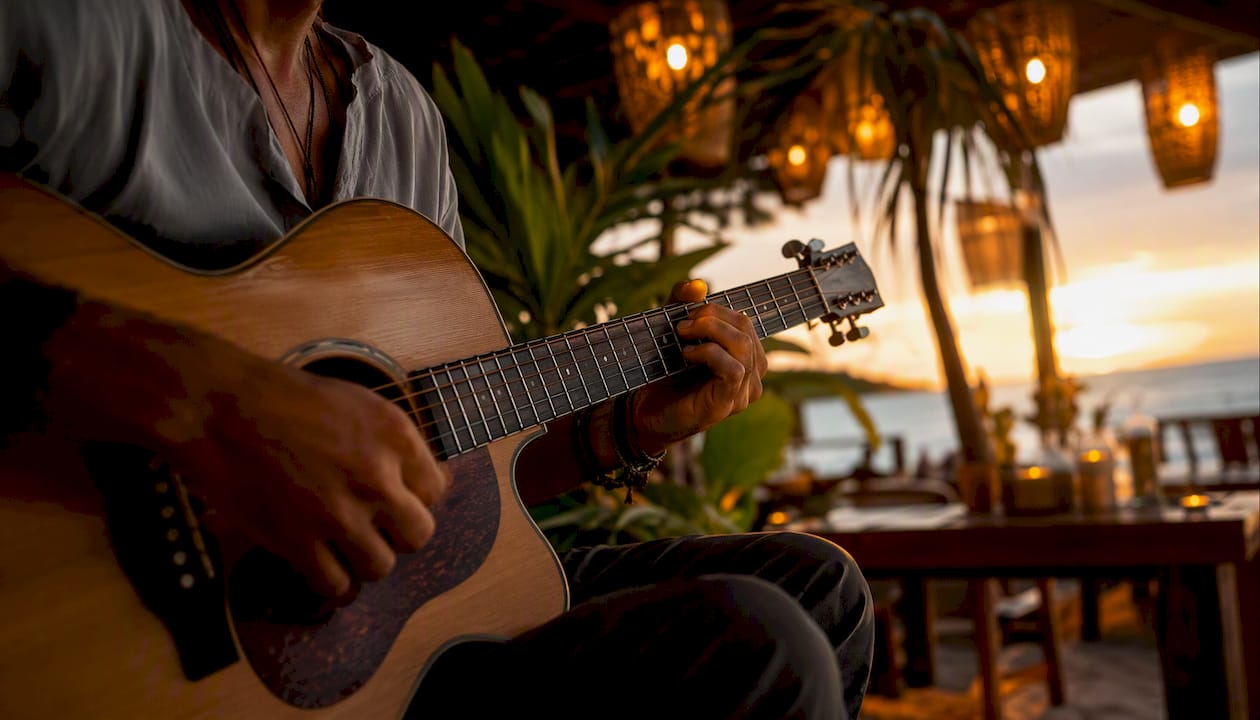 Hands playing acoustic guitar on restaurant patio