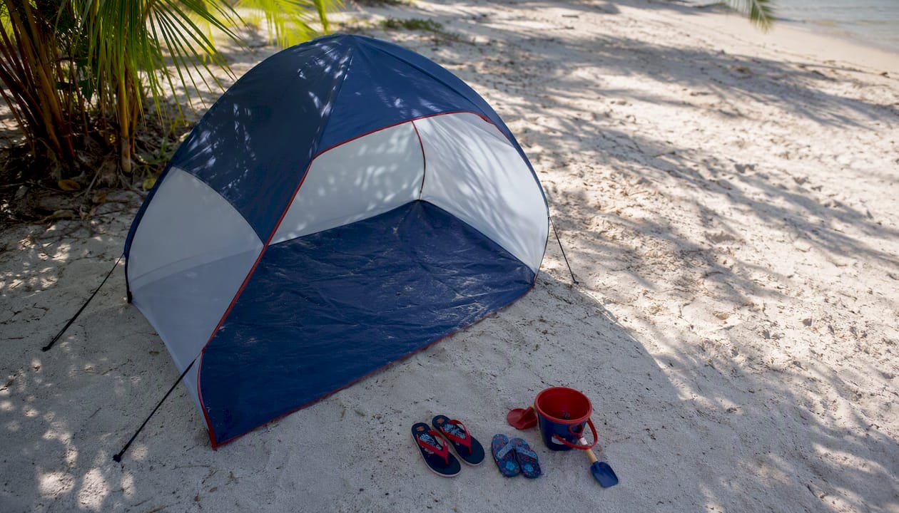 Pop-up beach tent with children's sand toys