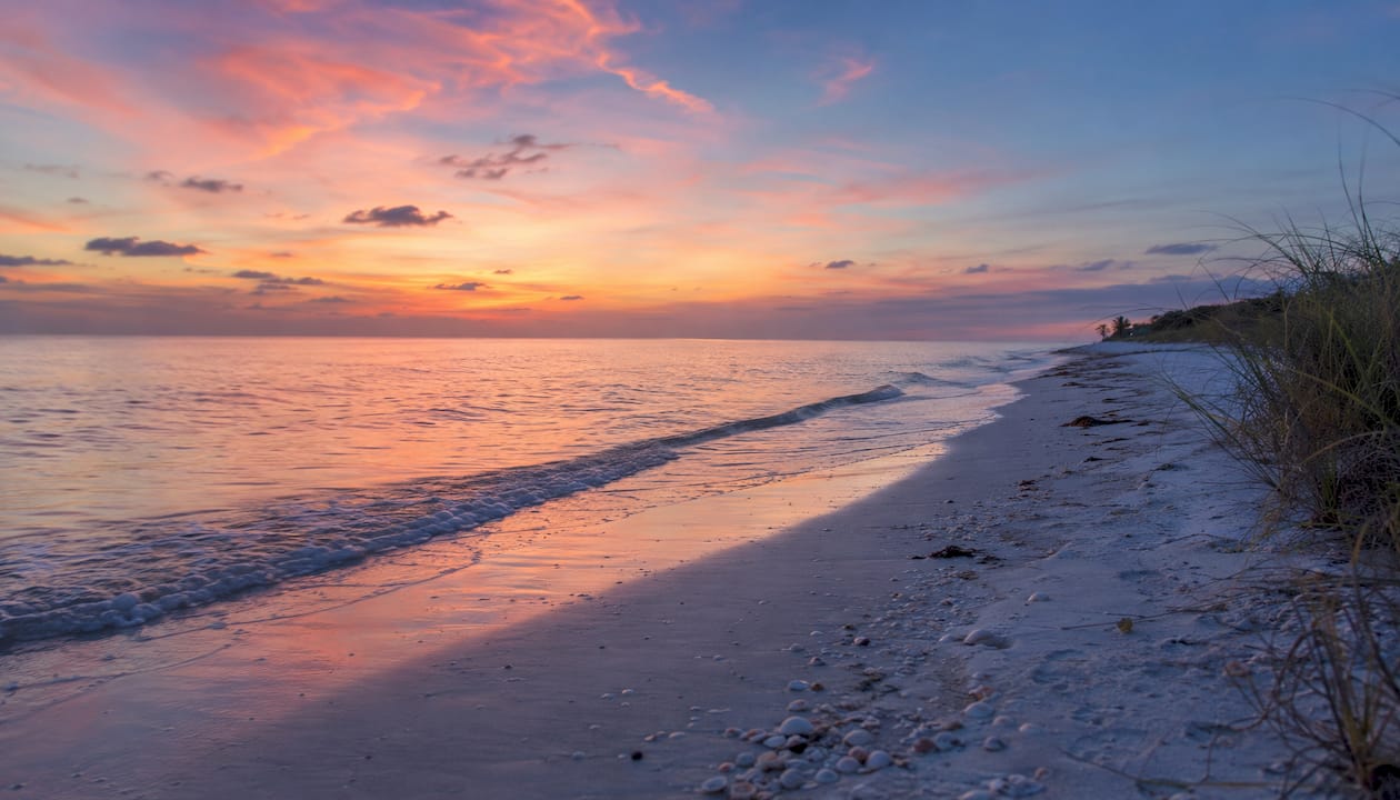 Golden sunset over Captiva beach dunes and ocean