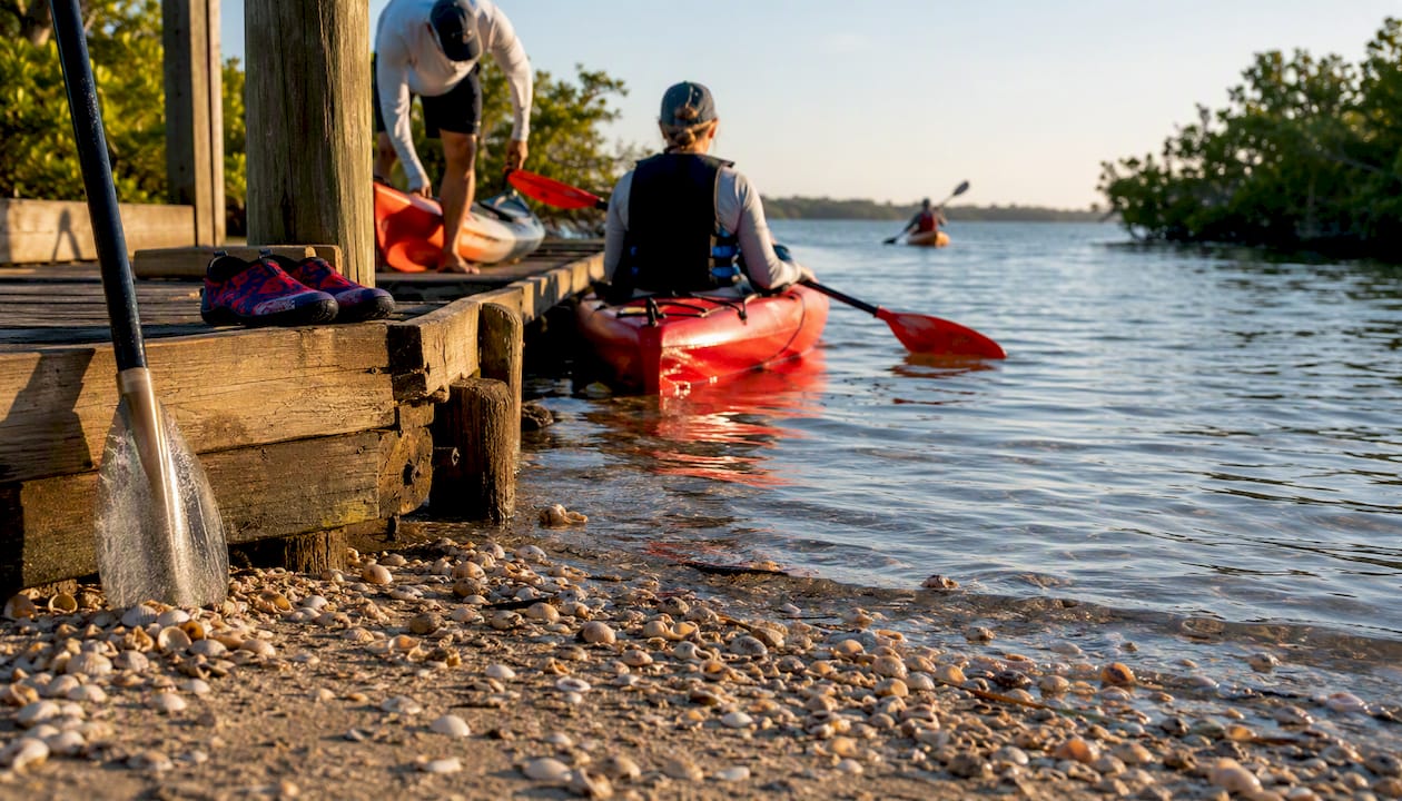 Kayak launch on calm bay water at sunrise
