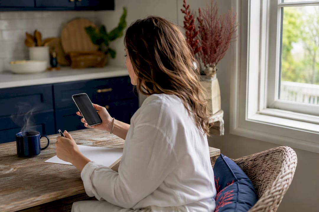 Hands verifying vacation rental listings on smartphone