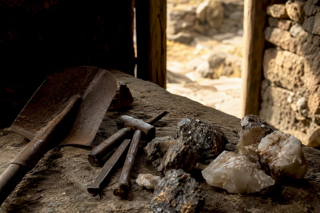 Mining tools and raw ores on wood table