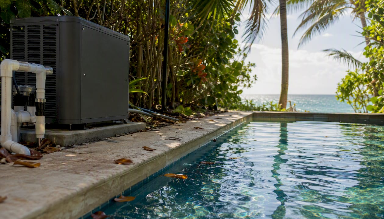 Heat pump pool heater by tropical outdoor pool