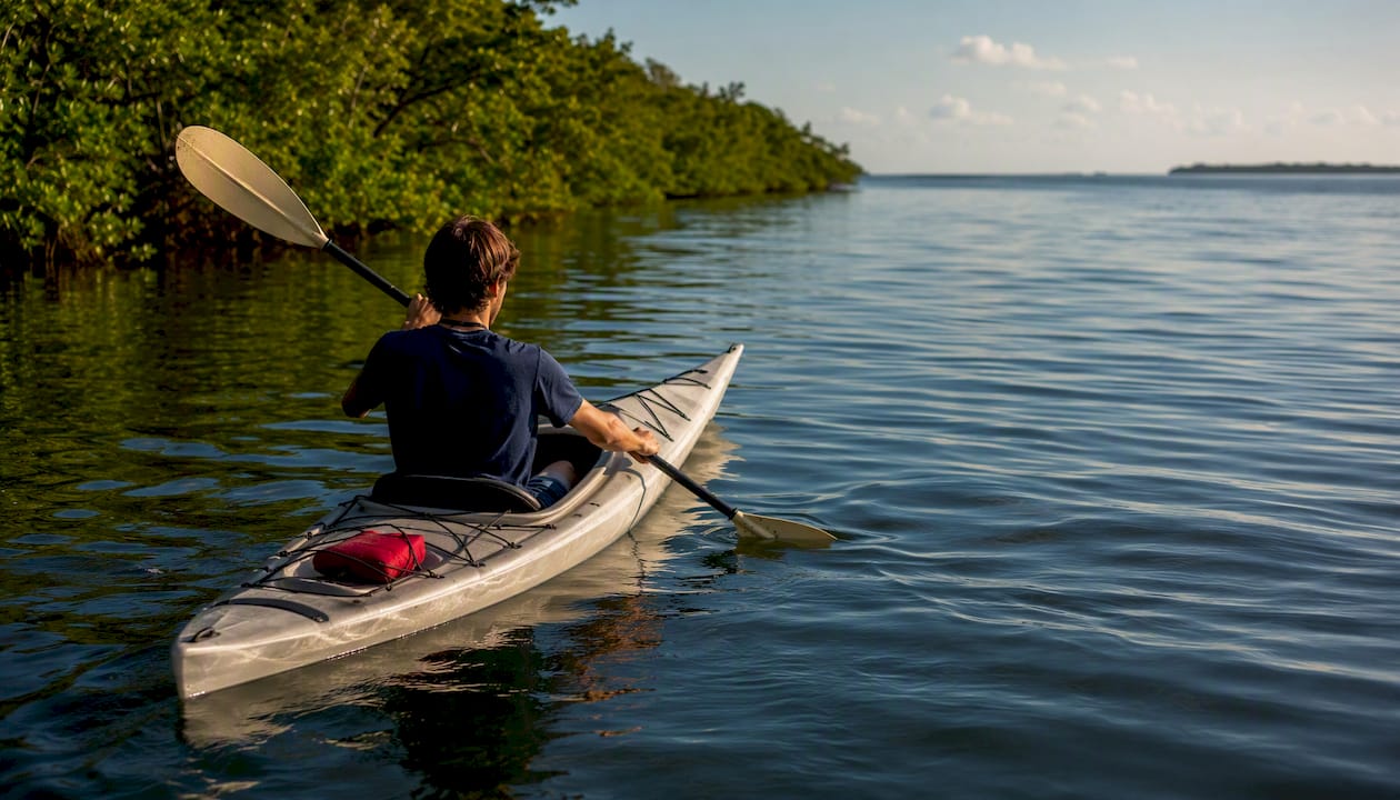 Teen kayaking through Captiva back bay