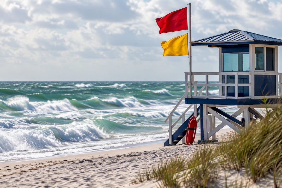 Warning flags above rough Florida surf