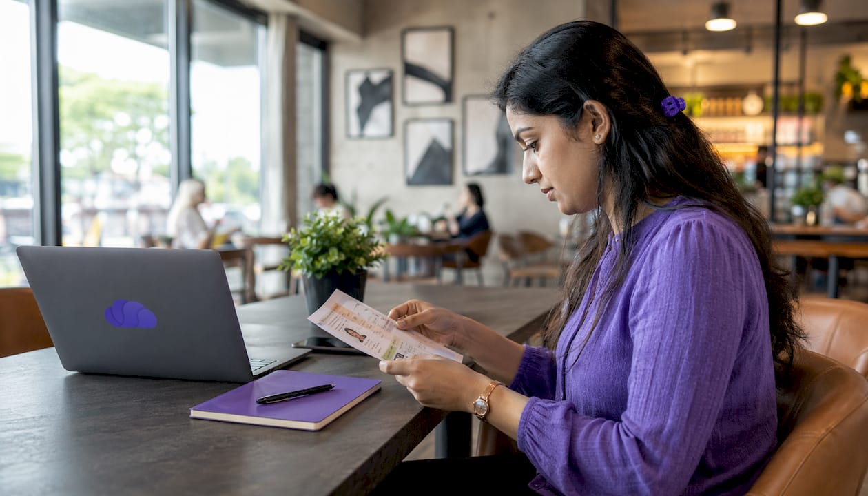 Woman reviewing onboarding documents at desk