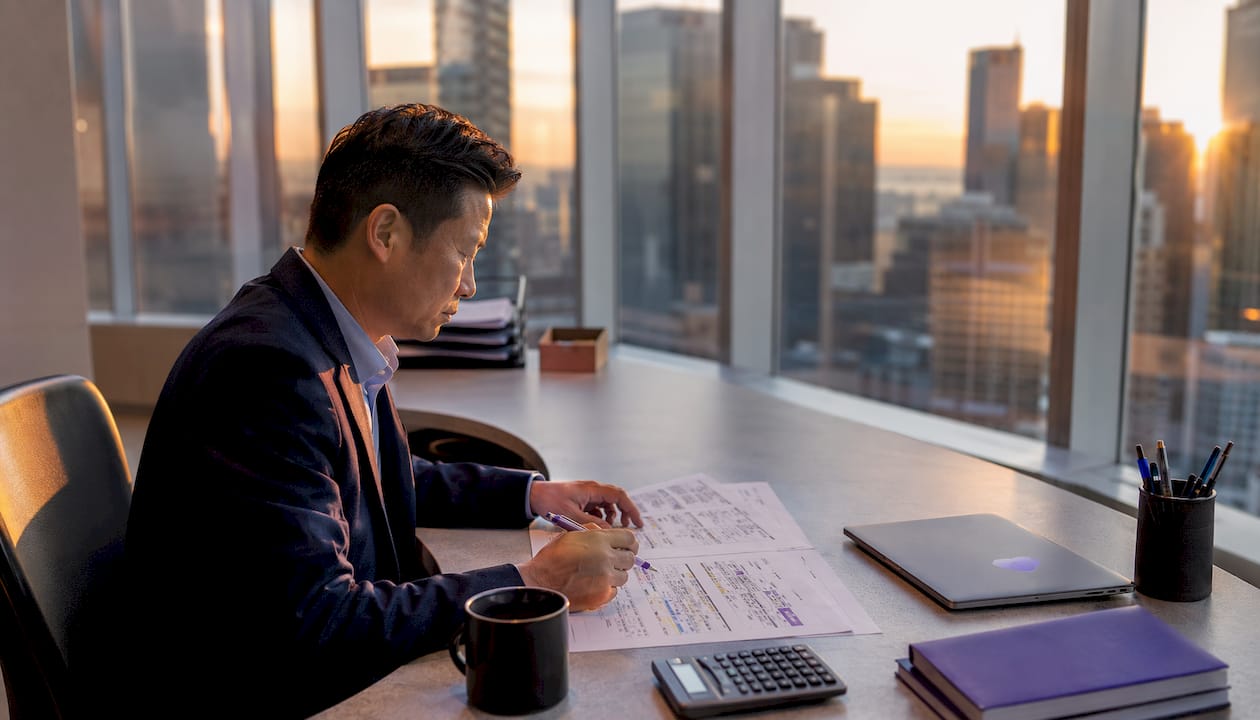 Trader reviewing futures desk charts at office