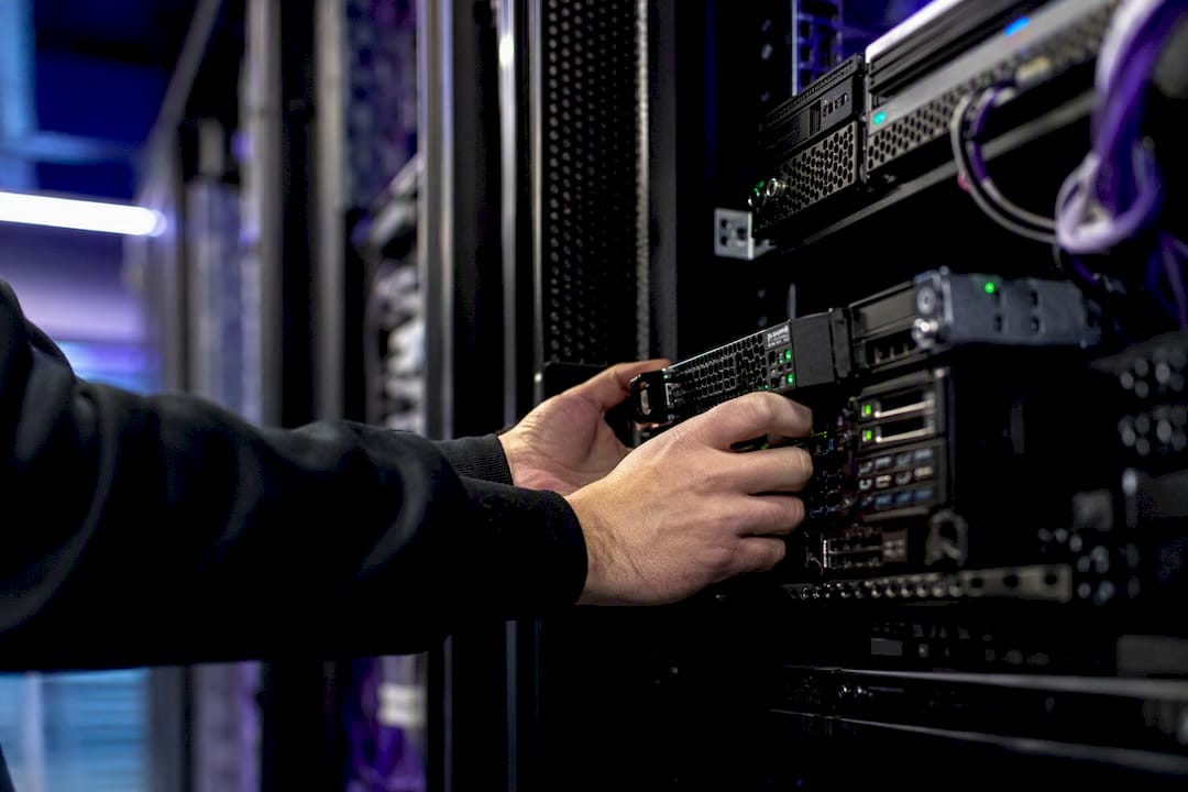 Hands installing kill switch hardware in server rack