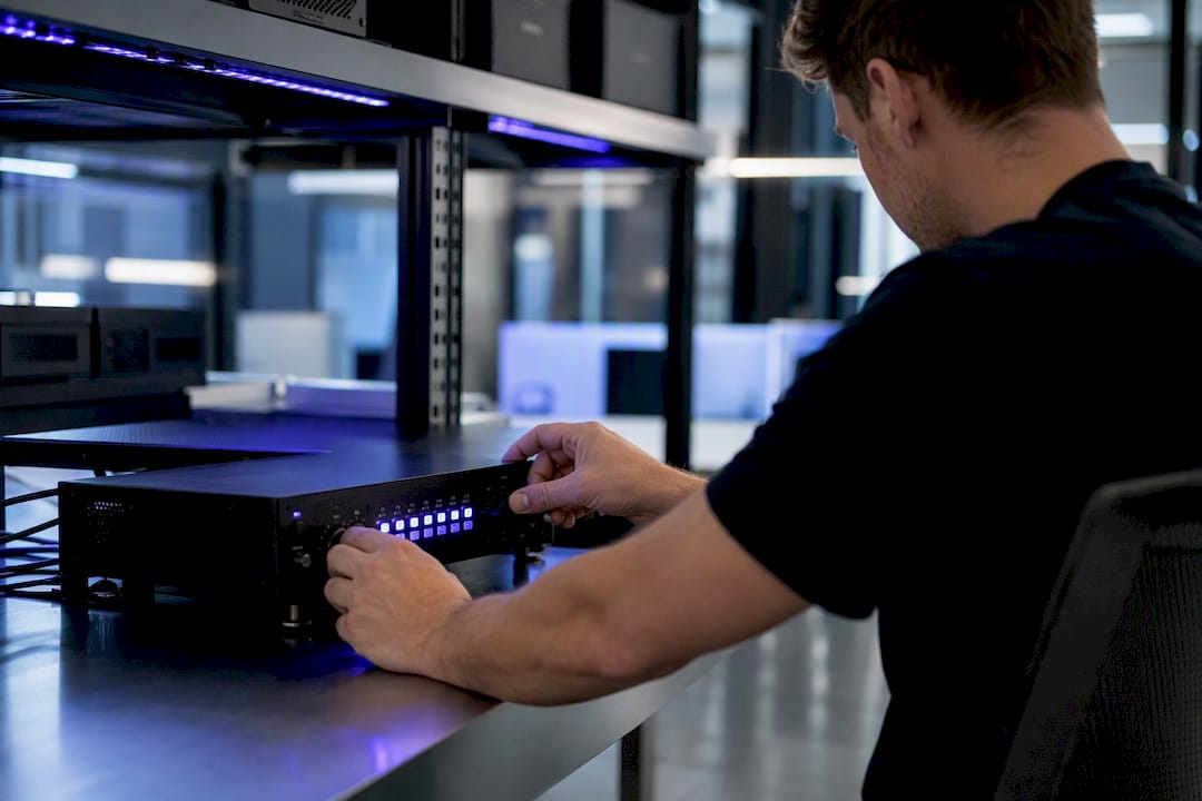 Hands adjusting latency control device in trading room