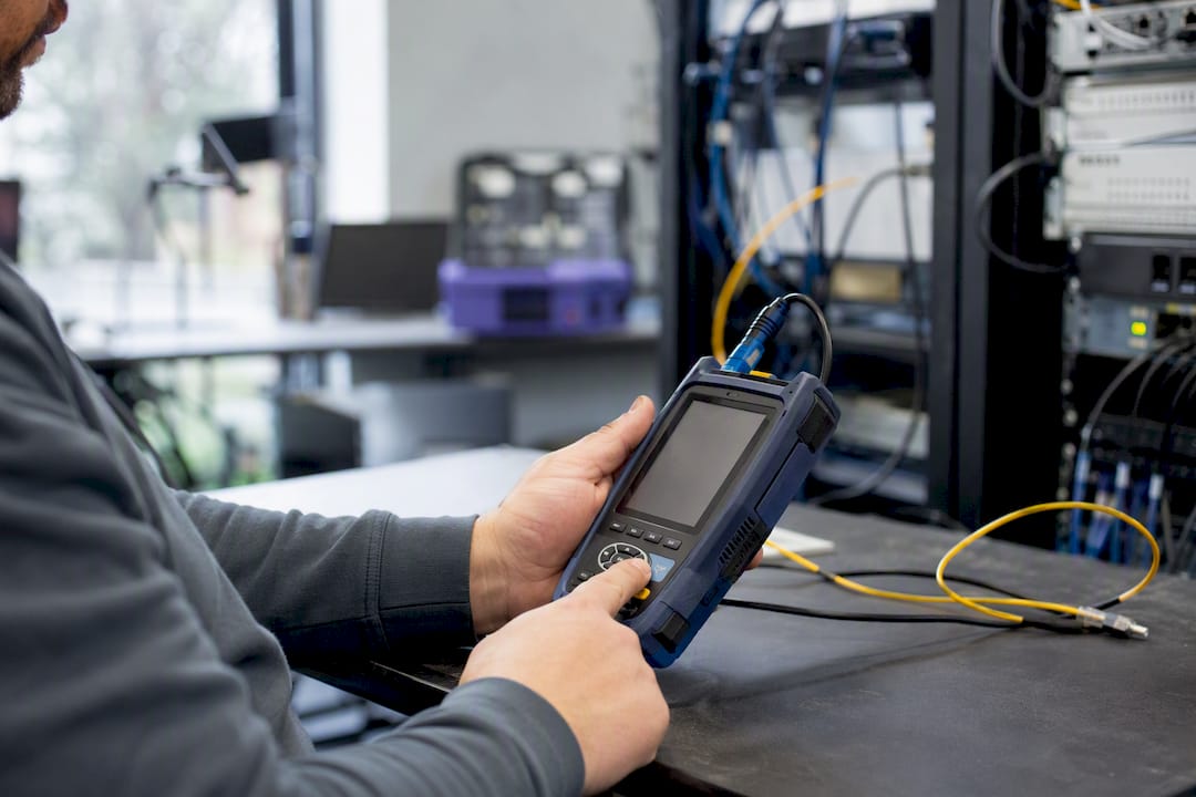 Hands pressing retry on network diagnostic device
