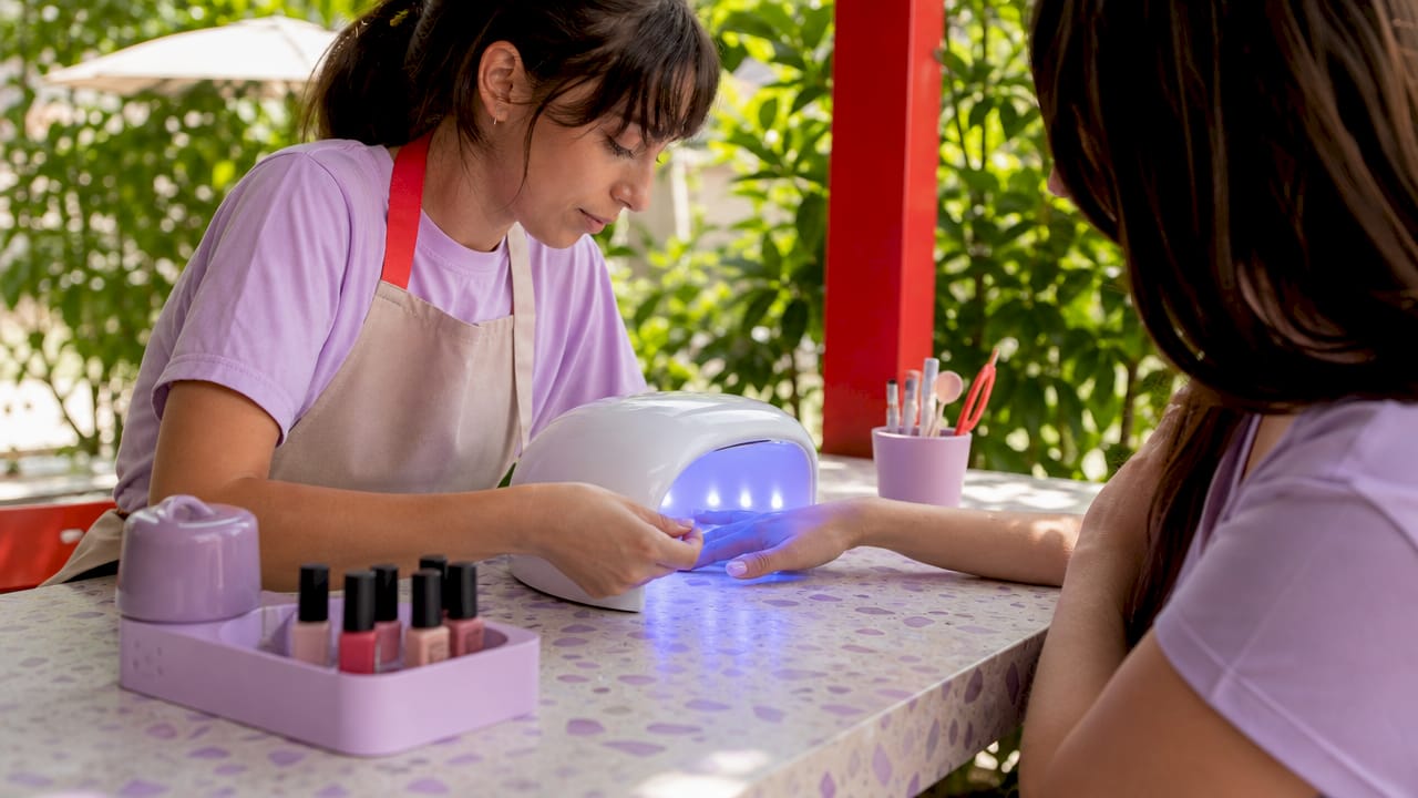 Hand curing no-chip gel manicure under LED lamp