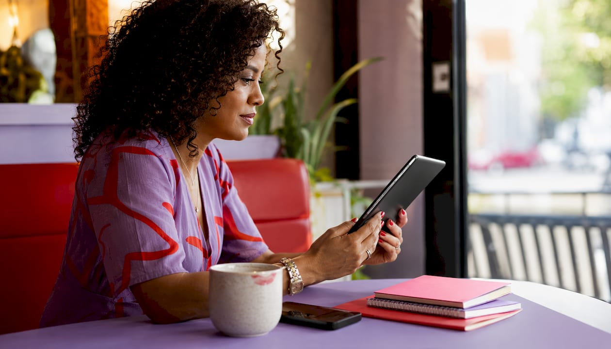 Woman reviewing salon booking alternatives on tablet
