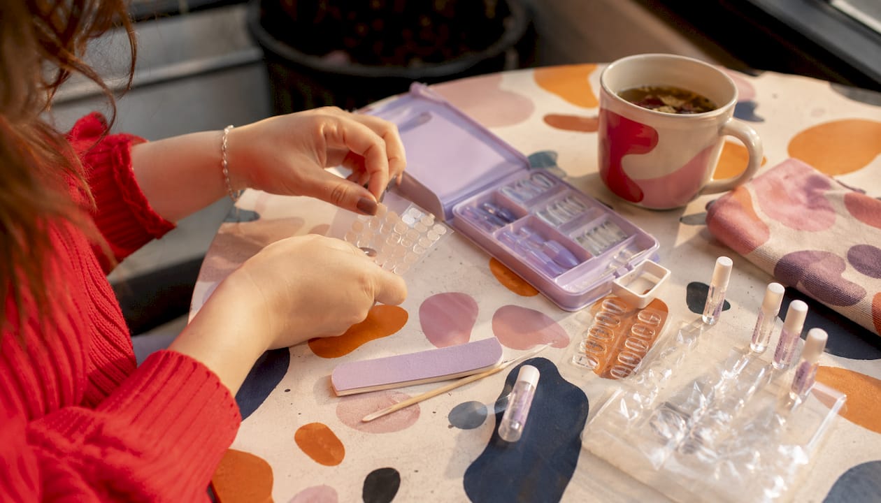 Overhead view of press-on nail kit components on table
