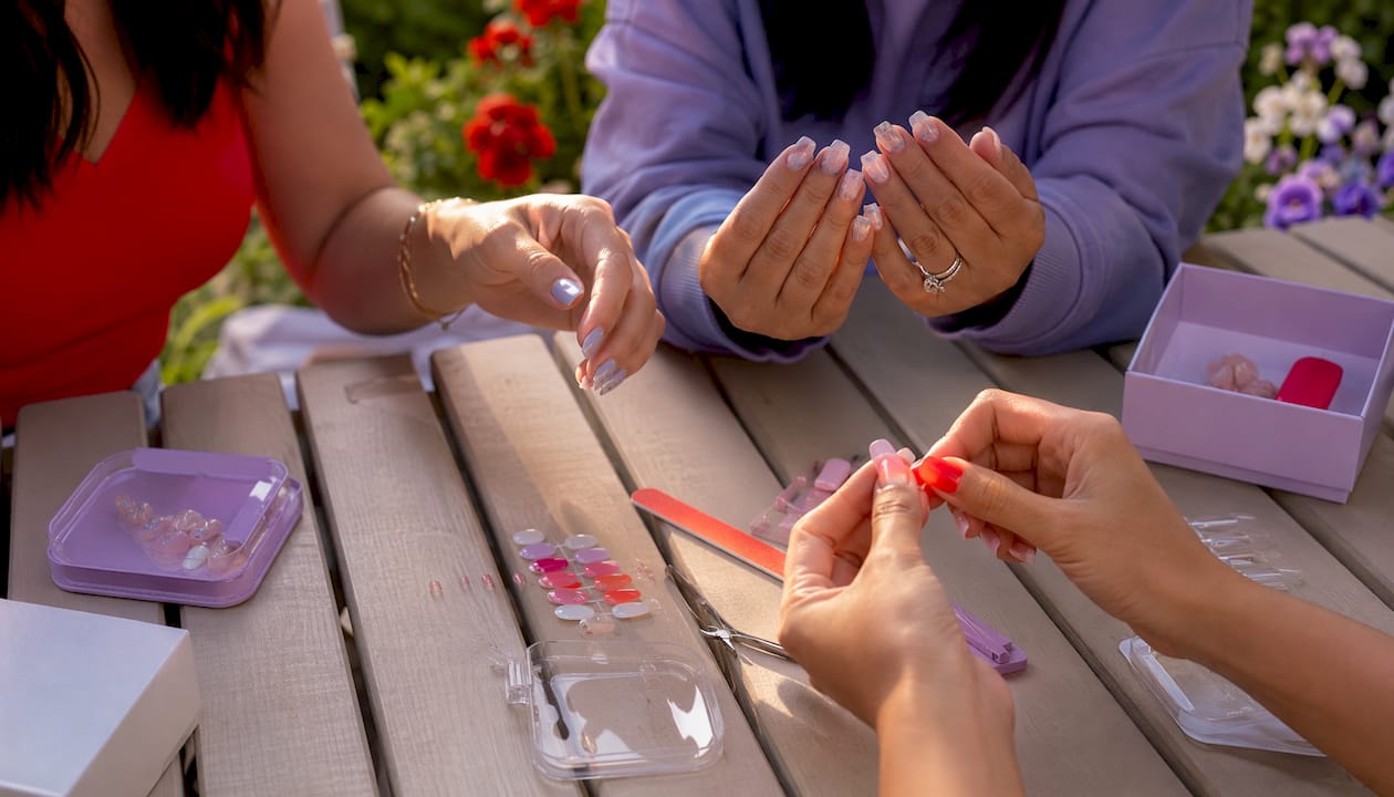 Close-up of varied press-on nail styles on hands