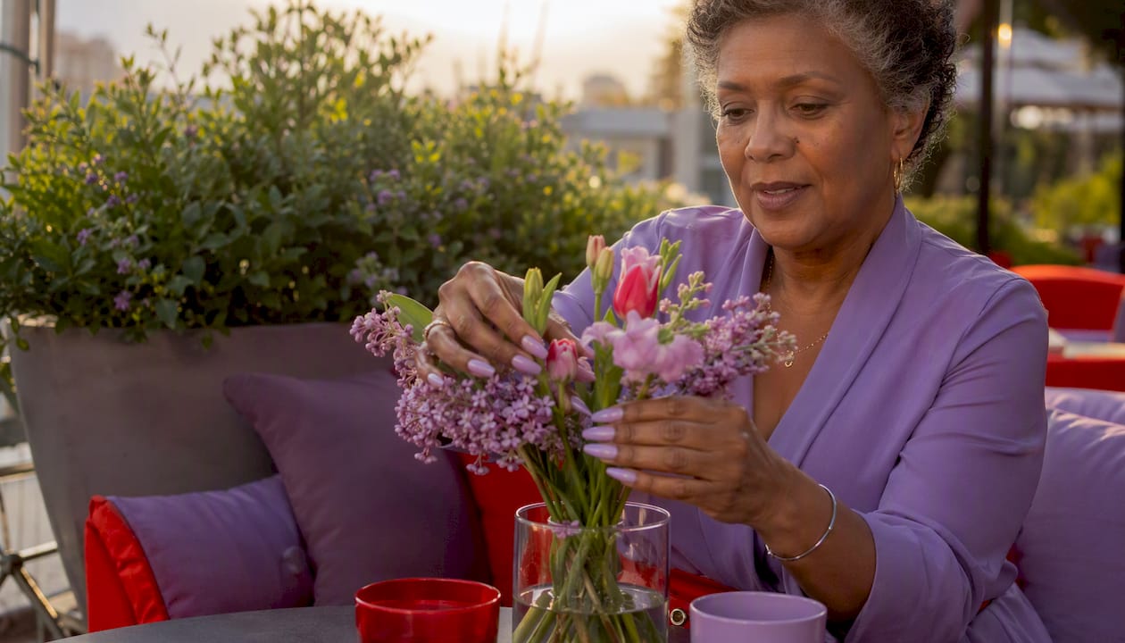 Lavender sheer nails holding flower vase outdoors