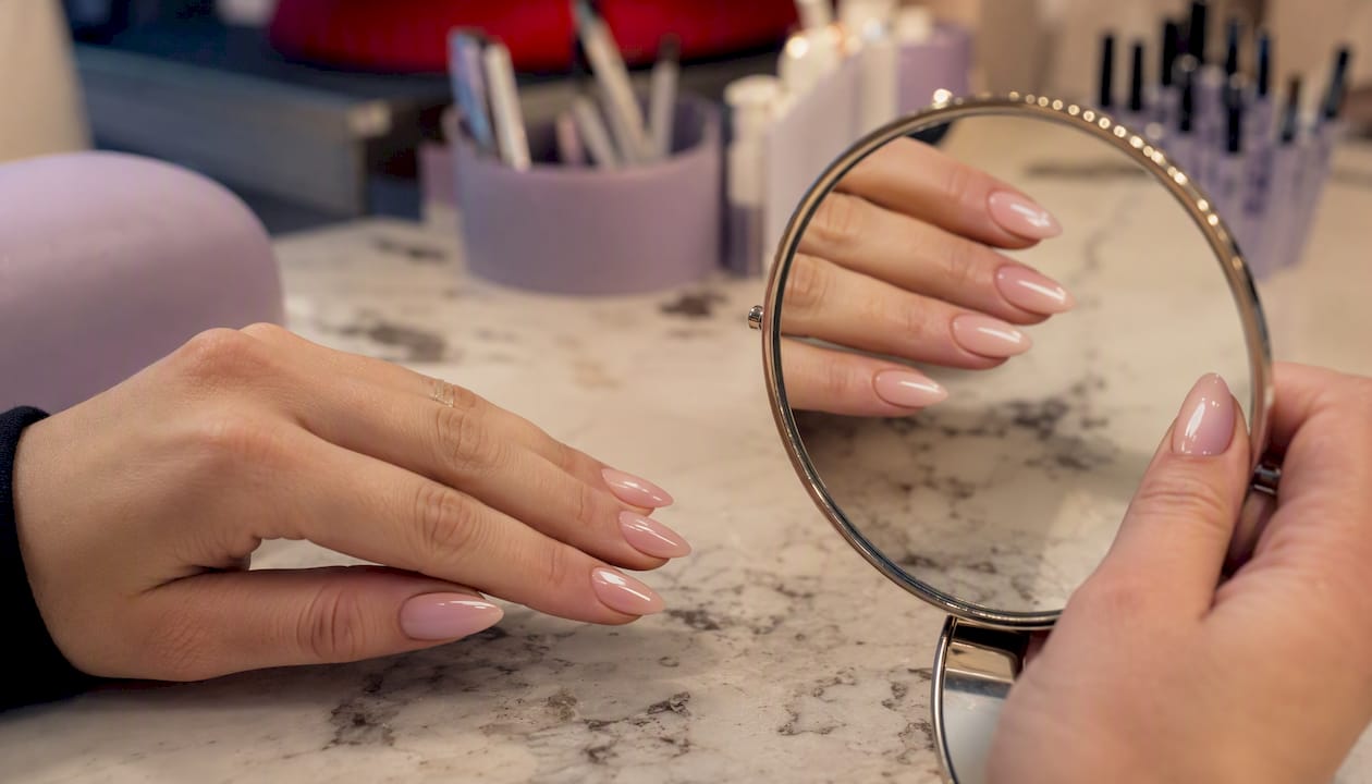 Close-up of flawless fresh manicure with mirror