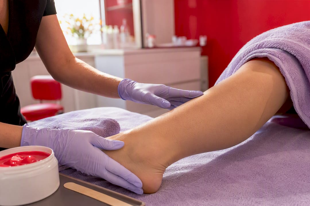 Technician inspecting hair before waxing